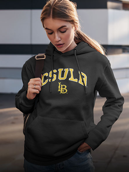 A girl is wearing a California State University Long Beach hoodie of campus design