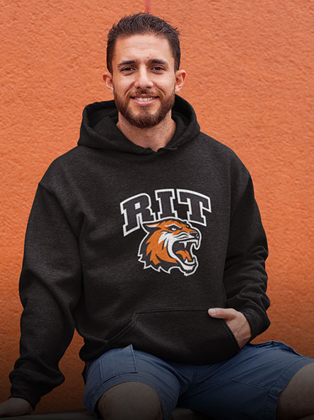 A man is wearing a Rochester Institute of Technology hoodie of freshman design