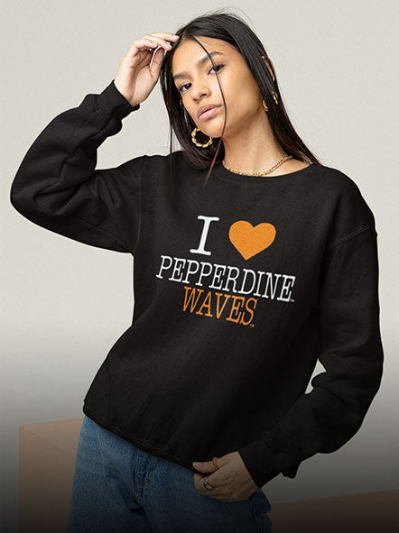 A girl is wearing a Pepperdine University Waves sweatshirt of i love design