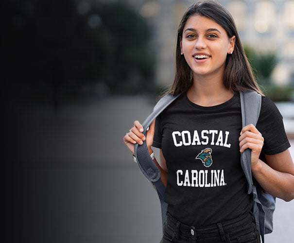A woman is wearing coastal carolina black t-shirt