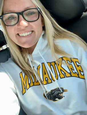 Customer Review: A blonde student wearing a Milwaukee hoodie