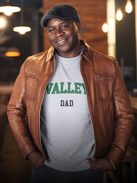 A black man is wearing a Mississippi Valley State University t-shirt with word dad