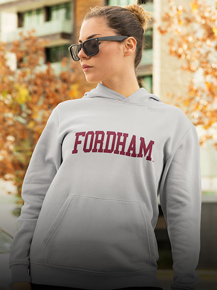 A girl is wearing a Fordham University Rams Hoodie of game day design