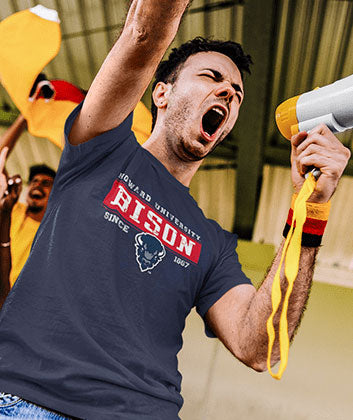 A man is wearing a Howard University Bison T-shirt at a game