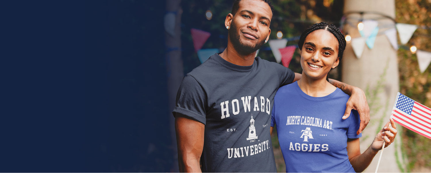 A black guy and girl wearing Howard and Aggies Universities tees holding USA flag in hand