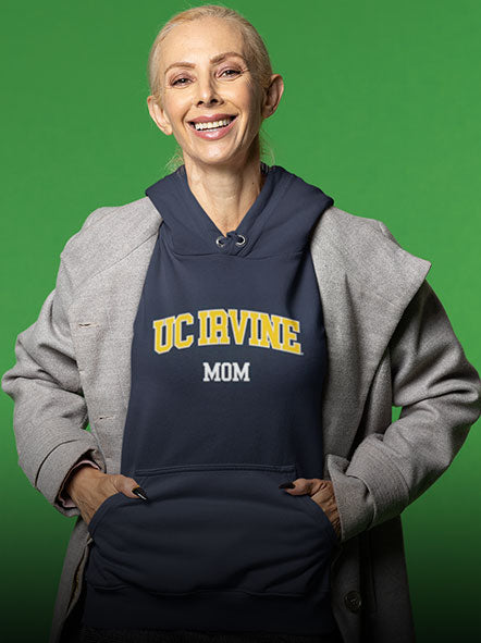 A woman is wearing a University of California UC Irvine Anteaters hoodie of word mom