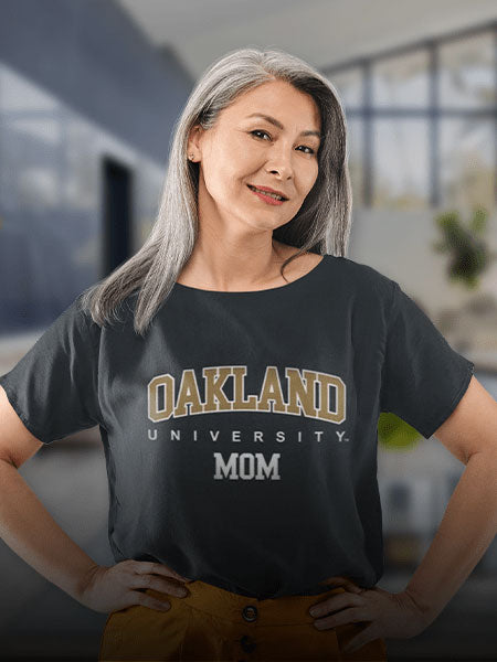 A woman wearing an Oakland University T-shirt with the word Mom 