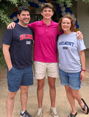Customer review: A proud dad and mom wearing t-shirts with the word Dad and Mom, posing with their college student son
